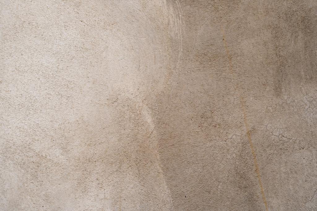 Warm neutral decorative plaster texture with natural movement