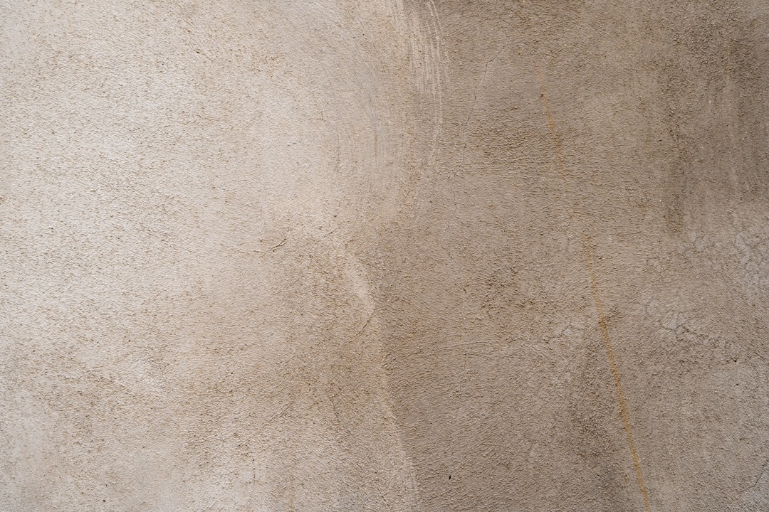 Warm neutral decorative plaster texture with natural movement